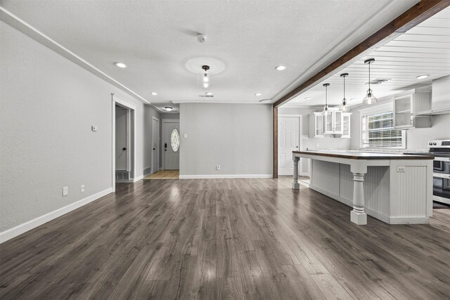 512 Judith St, Burleson, TX 76028 - unfurnished living room featuring dark wood-style floors, a textured ceiling, baseboards, and recessed lighting