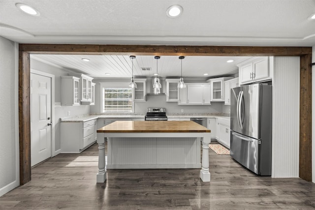 512 Judith St, Burleson, TX 76028 - kitchen with appliances with stainless steel finishes, wood counters, wall chimney exhaust hood, dark wood-type flooring, and recessed lighting