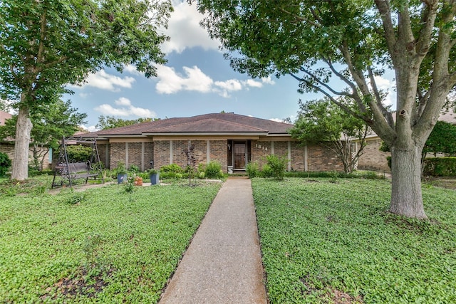 1614 Windsong Trl, Richardson, TX 75081 - single story home featuring a front lawn and brick siding