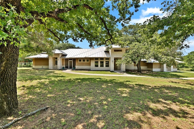 1212 Porter Rd, Bartonville, TX 75022 - rear view of house featuring a lawn, a standing seam roof, metal roof, and brick siding