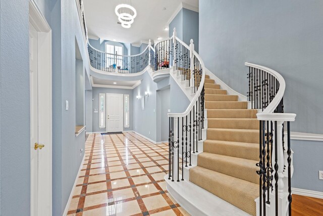 3804 Morning Dove Dr, Plano, TX 75025 - entryway featuring a towering ceiling, stairway, ornamental molding, baseboards, and inlaid floor details