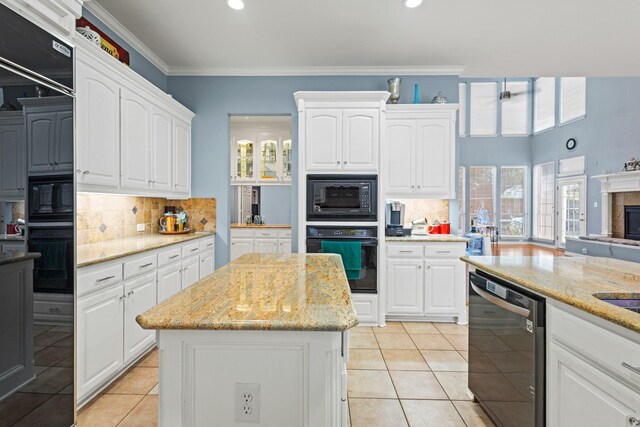 3804 Morning Dove Dr, Plano, TX 75025 - kitchen with black appliances, light tile patterned floors, backsplash, white cabinetry, and light stone counters