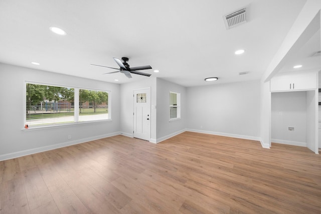 2415 Falls Dr, Dallas, TX 75211 - unfurnished living room featuring a ceiling fan, light wood finished floors, baseboards, and recessed lighting