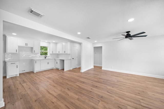 2415 Falls Dr, Dallas, TX 75211 - unfurnished living room featuring a sink, light wood finished floors, recessed lighting, baseboards, and ceiling fan