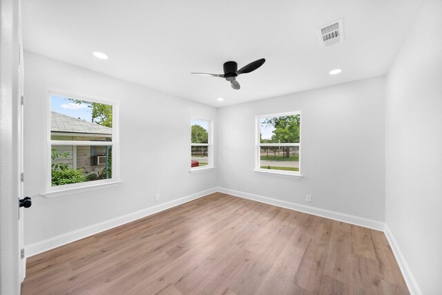 2415 Falls Dr, Dallas, TX 75211 - empty room featuring healthy amount of natural light, light wood-style floors, ceiling fan, baseboards, and recessed lighting