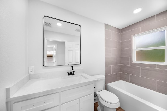 2415 Falls Dr, Dallas, TX 75211 - bathroom with toilet, vanity, recessed lighting, and shower / tub combination