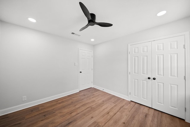 2415 Falls Dr, Dallas, TX 75211 - unfurnished bedroom with wood finished floors, baseboards, recessed lighting, a closet, and a ceiling fan