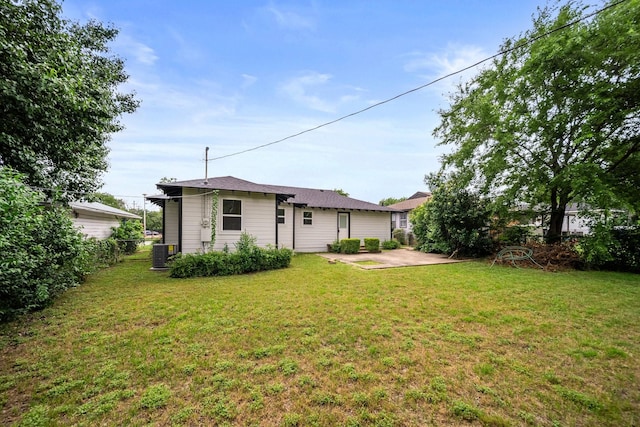 2415 Falls Dr, Dallas, TX 75211 - back of house featuring a patio area, central AC unit, and a yard