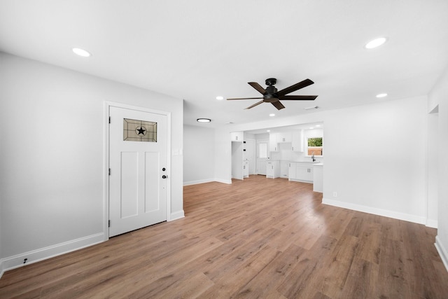 2415 Falls Dr, Dallas, TX 75211 - unfurnished living room featuring ceiling fan, recessed lighting, light wood finished floors, and baseboards
