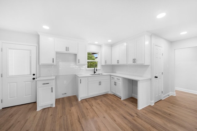 2415 Falls Dr, Dallas, TX 75211 - kitchen with a sink, light wood finished floors, white cabinetry, decorative backsplash, and recessed lighting