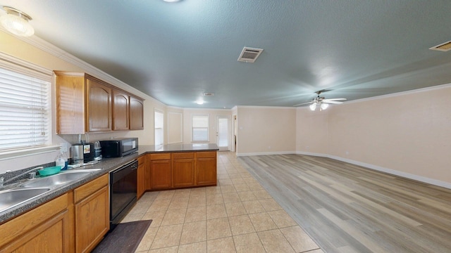 2008 Pine Knot Dr, Heartland, TX 75126 - kitchen with black appliances, a ceiling fan, dark countertops, healthy amount of natural light, and crown molding