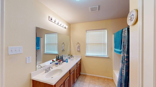 2008 Pine Knot Dr, Heartland, TX 75126 - bathroom featuring double vanity, baseboards, tile patterned floors, and shower / bath combo