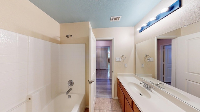 2008 Pine Knot Dr, Heartland, TX 75126 - bathroom featuring tub / shower combination, vanity, a textured ceiling, tile patterned floors, and baseboards