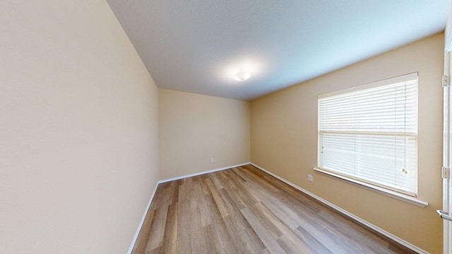 2008 Pine Knot Dr, Heartland, TX 75126 - unfurnished room with light wood-style floors, healthy amount of natural light, and baseboards