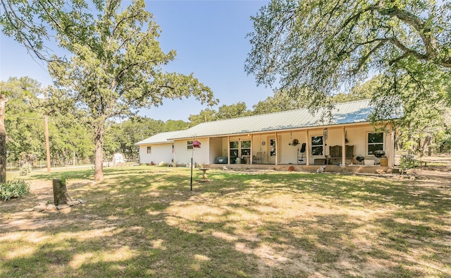 1055 Miller Rd, Reno, TX 76020 - rear view of house with metal roof, a yard, and covered porch