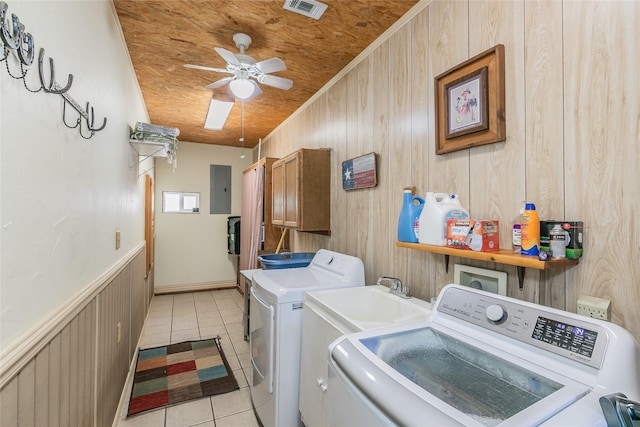 1055 Miller Rd, Reno, TX 76020 - washroom with separate washer and dryer, light tile patterned flooring, electric panel, wooden walls, and ceiling fan