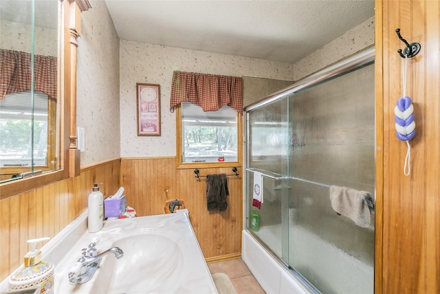 1055 Miller Rd, Reno, TX 76020 - full bathroom featuring combined bath / shower with glass door, wainscoting, wooden walls, tile patterned floors, and vanity