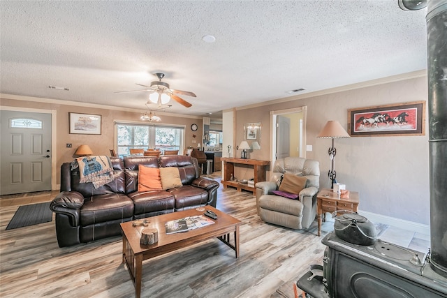 1055 Miller Rd, Reno, TX 76020 - living area with a textured ceiling, crown molding, light wood-style floors, a ceiling fan, and baseboards