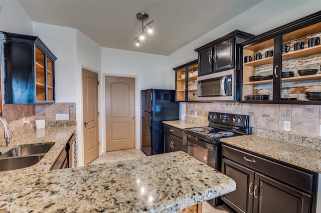 103 Presidents Way, Venus, TX 76084 - kitchen with black appliances, a sink, decorative backsplash, light stone counters, and glass insert cabinets