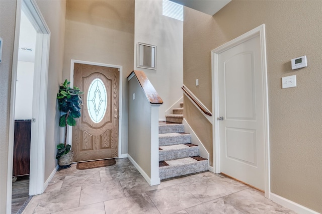 103 Presidents Way, Venus, TX 76084 - foyer entrance featuring stairway, a high ceiling, baseboards, light marble finish floors, and a textured wall