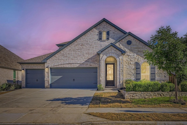 17204 Clover Dr, Celina, TX 75009 - french country home featuring driveway, a garage, and stone siding