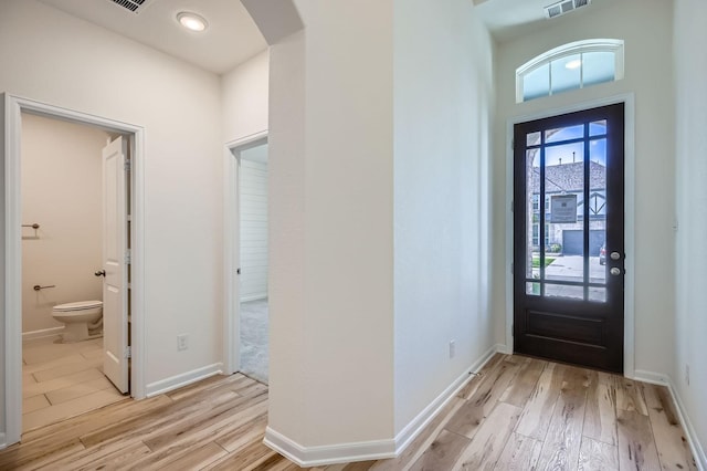 17204 Clover Dr, Celina, TX 75009 - entryway with light wood-style floors, arched walkways, and baseboards