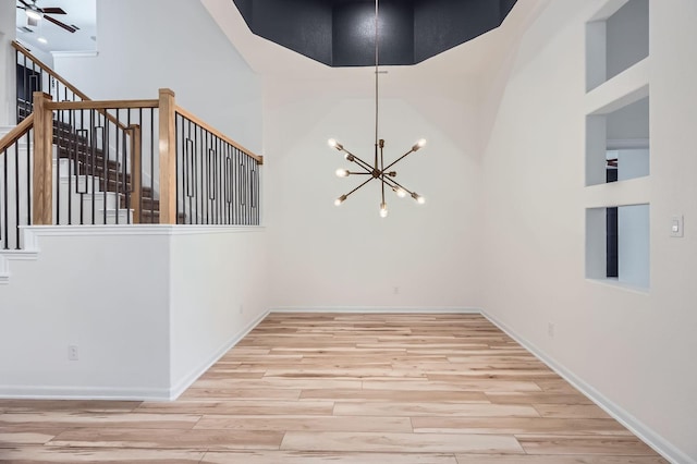 17204 Clover Dr, Celina, TX 75009 - unfurnished room with a high ceiling, wood finished floors, a chandelier, stairway, and baseboards