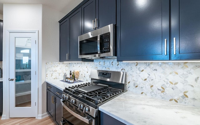17204 Clover Dr, Celina, TX 75009 - kitchen with stainless steel appliances, backsplash, light wood finished floors, and light stone countertops