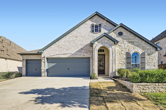 17204 Clover Dr, Celina, TX 75009 - french country style house with an attached garage, driveway, and brick siding