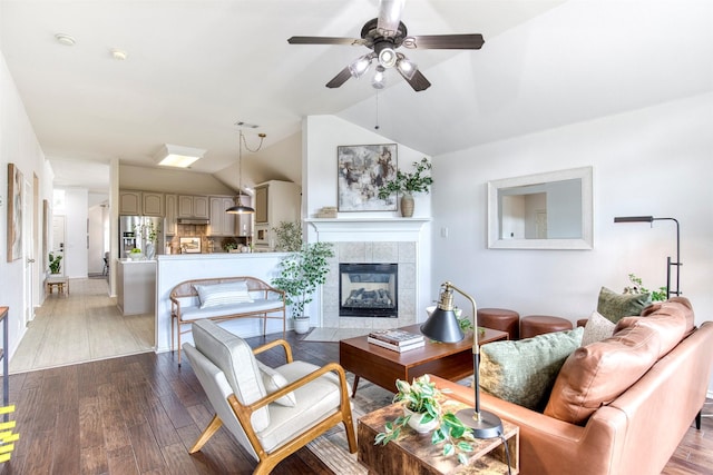 11471 Balcones Dr, Frisco, TX 75033 - living room featuring vaulted ceiling, a ceiling fan, a fireplace, and light wood-type flooring