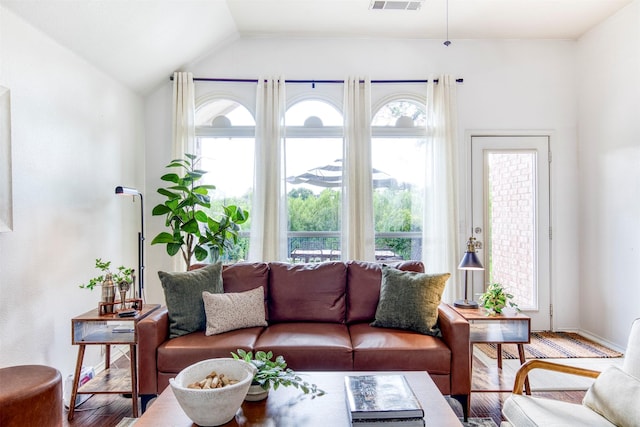 11471 Balcones Dr, Frisco, TX 75033 - living room featuring wood finished floors, vaulted ceiling, and baseboards