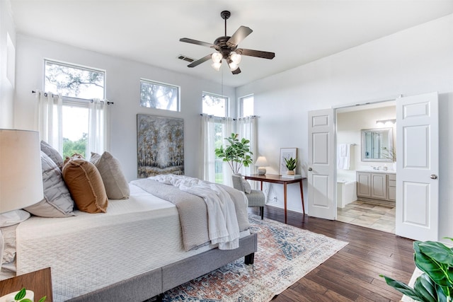 11471 Balcones Dr, Frisco, TX 75033 - bedroom with hardwood / wood-style floors, connected bathroom, baseboards, and ceiling fan
