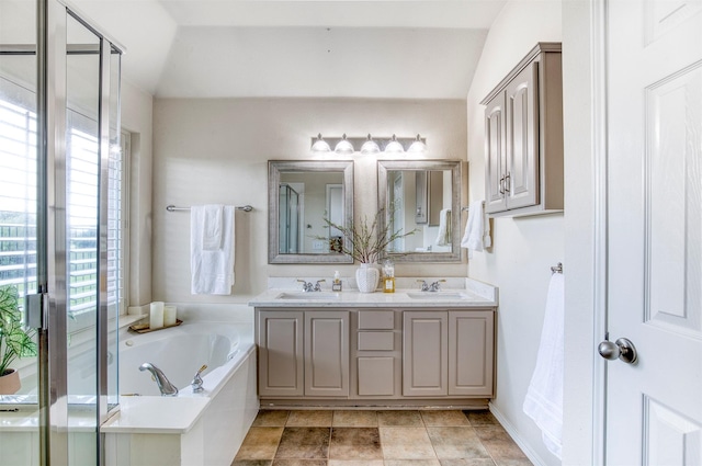11471 Balcones Dr, Frisco, TX 75033 - bathroom with double vanity, a garden tub, a stall shower, and vaulted ceiling