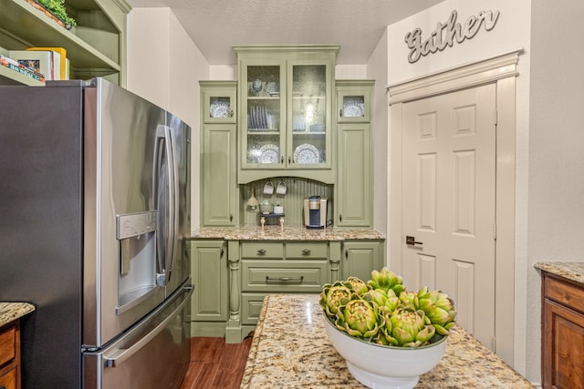 1702 Clarke Springs Dr, Allen, TX 75002 - kitchen with stainless steel refrigerator with ice dispenser, green cabinetry, dark wood-style floors, and light stone countertops