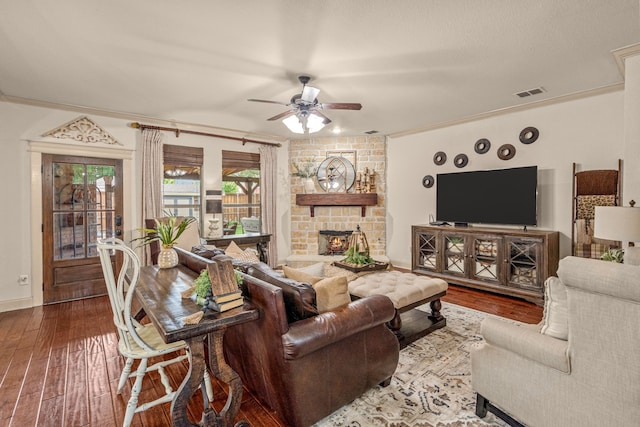 1702 Clarke Springs Dr, Allen, TX 75002 - living area with a ceiling fan, hardwood / wood-style flooring, a stone fireplace, baseboards, and crown molding