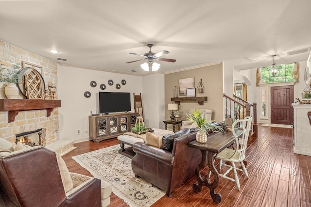 1702 Clarke Springs Dr, Allen, TX 75002 - living area with a fireplace, arched walkways, dark wood-style floors, a ceiling fan, and stairs