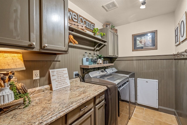 1702 Clarke Springs Dr, Allen, TX 75002 - laundry area with washer and clothes dryer, cabinet space, a wainscoted wall, and wooden walls