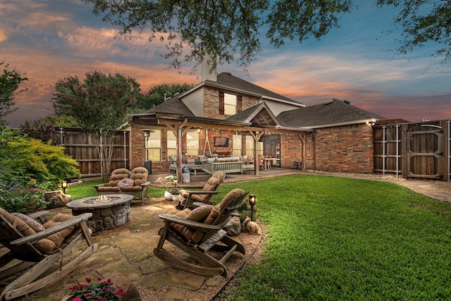 1702 Clarke Springs Dr, Allen, TX 75002 - back of property with an outdoor living space with a fire pit, a patio area, and brick siding