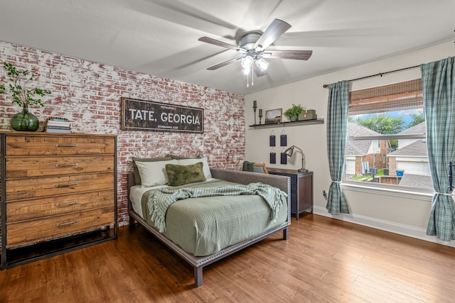 1702 Clarke Springs Dr, Allen, TX 75002 - bedroom with wood finished floors, baseboards, brick wall, and ceiling fan