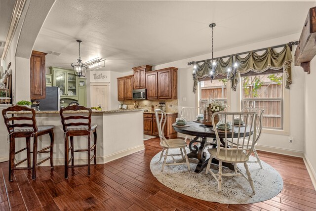 1702 Clarke Springs Dr, Allen, TX 75002 - dining area with a chandelier, dark wood-style flooring, and baseboards