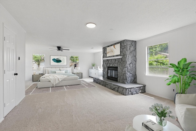 3622 Emerald Dr, Mesquite, TX 75150 - carpeted bedroom with a stone fireplace and ceiling fan