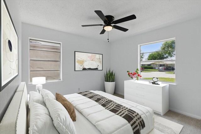 3622 Emerald Dr, Mesquite, TX 75150 - carpeted bedroom featuring a ceiling fan and a textured ceiling