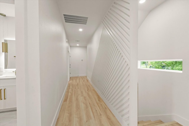1344 Compton St, Dallas, TX 75203 - corridor featuring a sink, light wood-style floors, recessed lighting, and baseboards