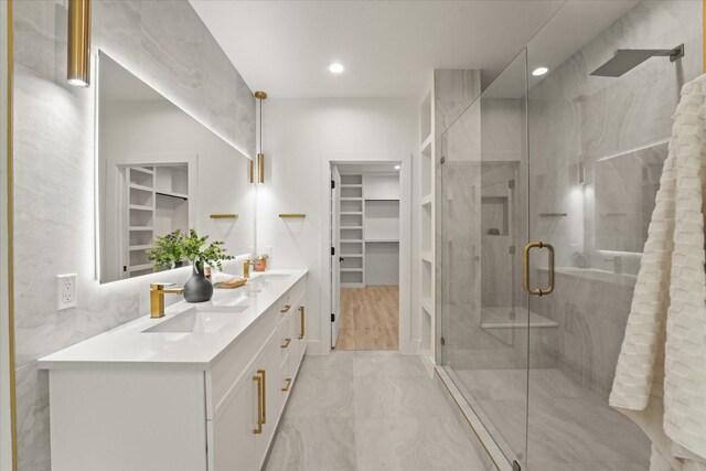 1344 Compton St, Dallas, TX 75203 - full bath featuring double vanity, a walk in closet, a stall shower, recessed lighting, and marble finish flooring