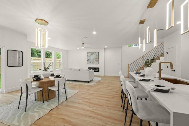 1344 Compton St, Dallas, TX 75203 - dining area with ceiling fan, light wood-style flooring, baseboards, stairway, and recessed lighting