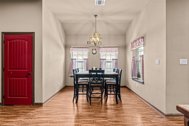 4905 Lakepark Dr, Sanger, TX 76266 - dining area with a chandelier, wood finished floors, baseboards, and lofted ceiling