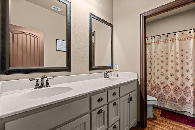 4905 Lakepark Dr, Sanger, TX 76266 - full bath with toilet, wood finished floors, double vanity, and curtained shower