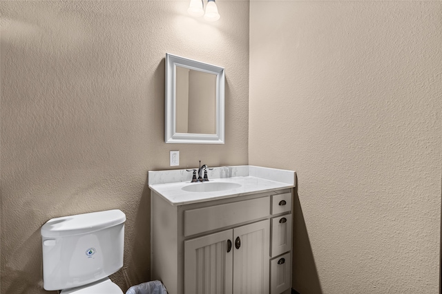4905 Lakepark Dr, Sanger, TX 76266 - bathroom with toilet, vanity, and a textured wall