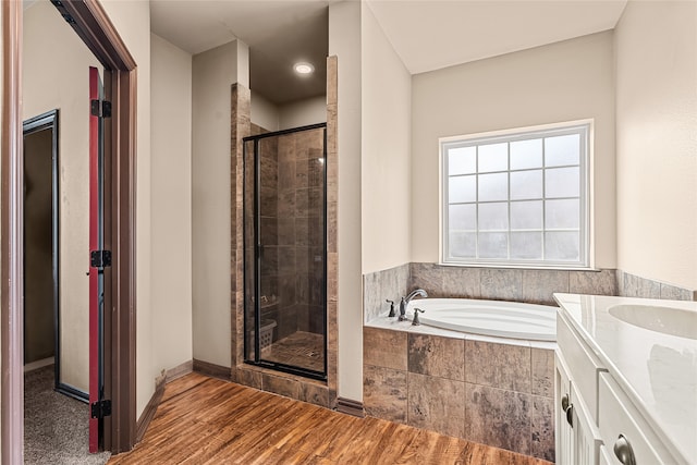 4905 Lakepark Dr, Sanger, TX 76266 - full bath with a stall shower, wood finished floors, a bath, vanity, and baseboards