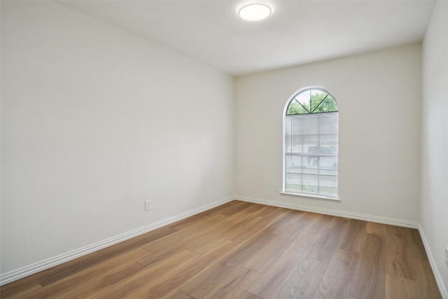 6420 Green Ridge Dr, Watauga, TX 76148 - spare room featuring wood finished floors and baseboards